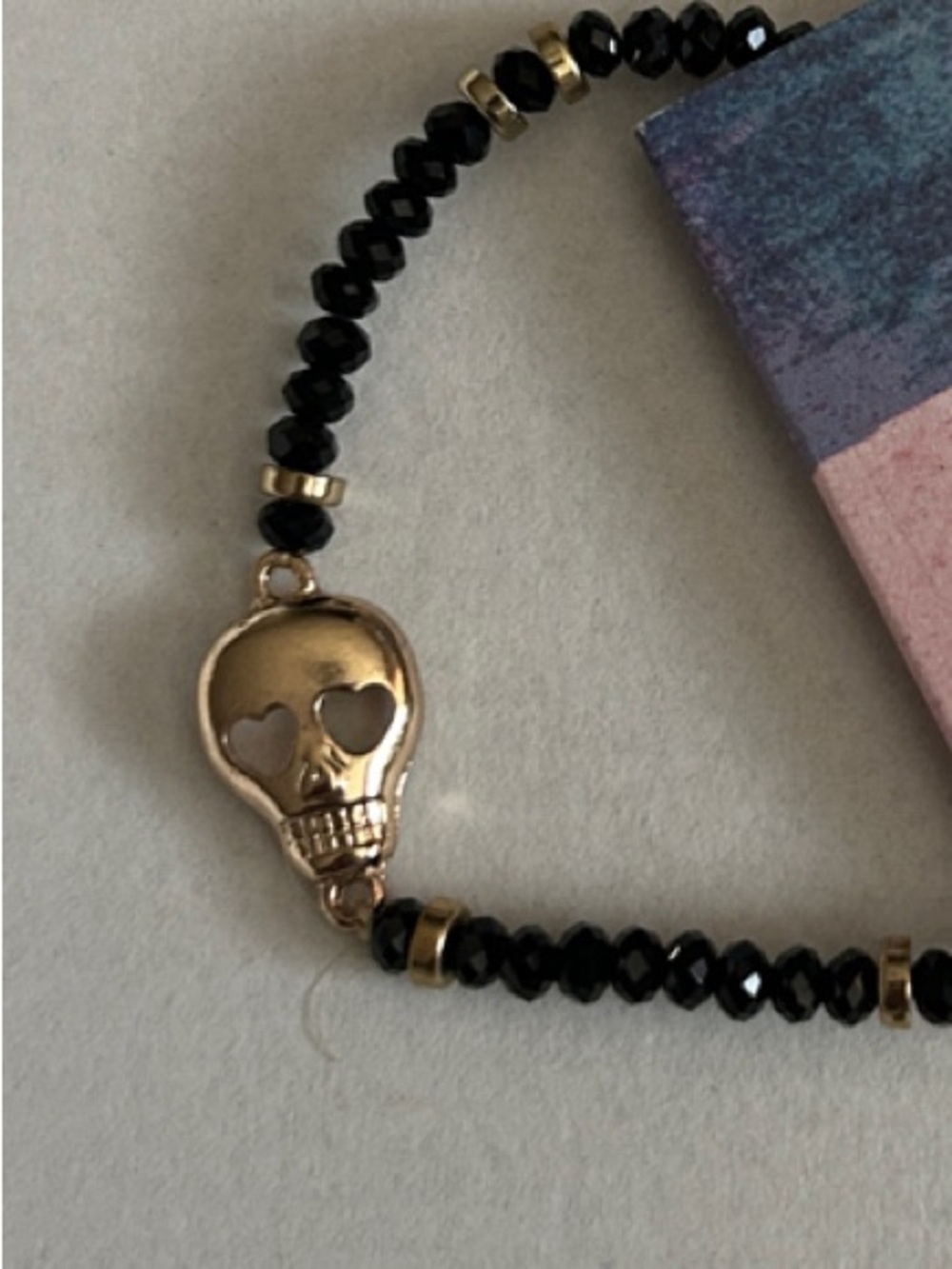 Gold Skull Bead Stretch Bracelet - Black Beads